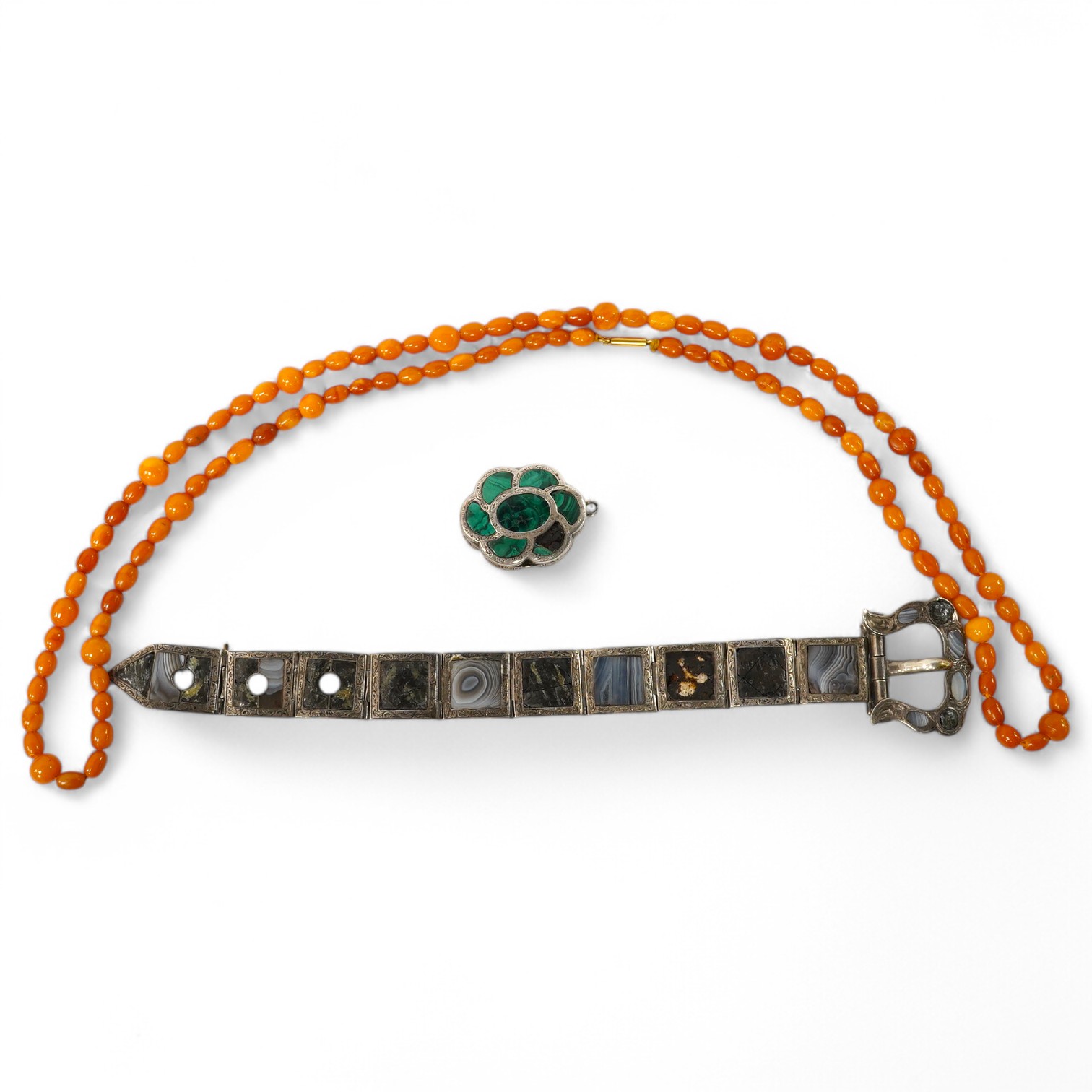 A single strand amber bead necklace, 72cm, gross weight 14 grams, together with a Victorian silver and malachite inset vinaigrette(a.f.) and a white metal and Scottish hardstone set bracelet(a.f.). Condition - poor to fa